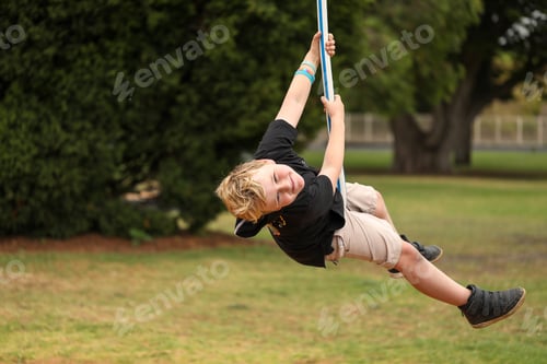 Preview: Cute blonde child having fun on the swing ride
