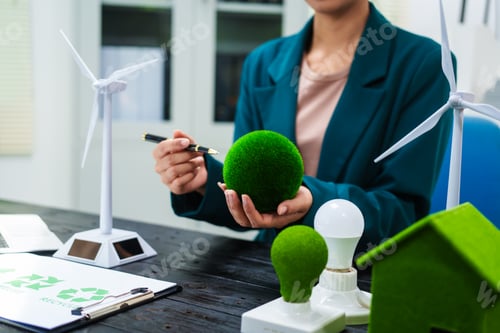 Preview: An Asian businesswoman sits at her desk, discussing clean energy solutions their impact on homes