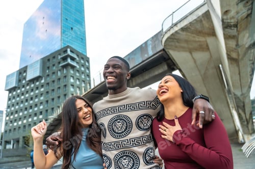Preview: Diverse young friends laughing together in urban setting