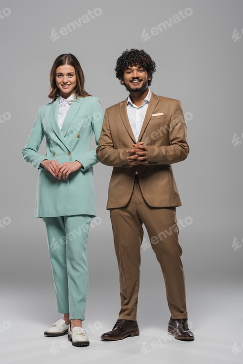 Preview: Full length of cheerful interracial event hosts in formal wear standing together and looking