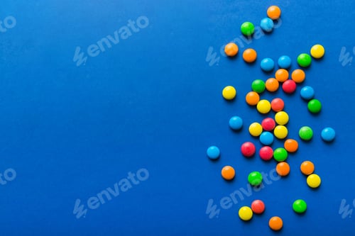 Preview: Mixed collection of colorful candy, on colored background. Flat lay, top view
