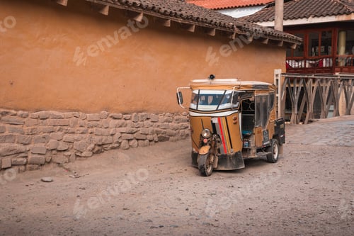 Preview: Tuk tuk parking near traditional earthen wall in peru