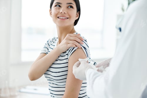 Preview: smiling woman in hospital making coronavirus vaccine