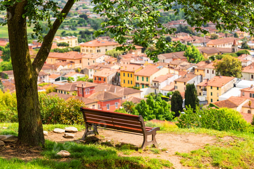 Preview: Beautiful view from the mountain on the Italian city, with wooden bench
