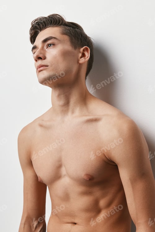 Preview: Cropped view of a sexy guy with a naked torso on a light background