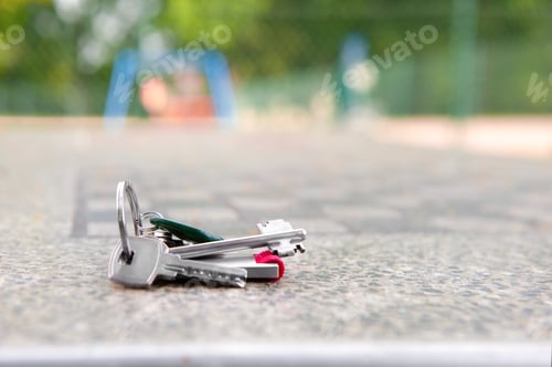 Preview: Keys forgotten on grey stone table outdoors. Space for text. Lost and found