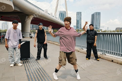Preview: Group of Friends Dancing Under Modern Bridge Structure