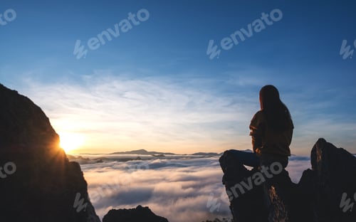 Preview: A female traveler sitting on the mountain peak, watching sunrise and sea of fog