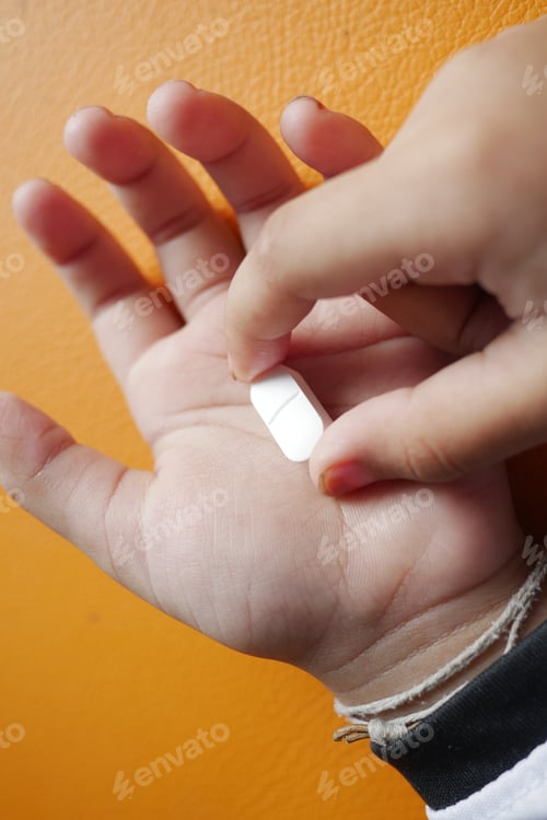 Preview: child taking medical pill close up