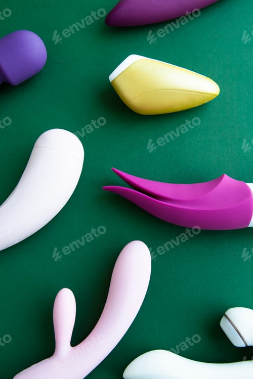 Preview: Collection of different types of sex toys on a green background.