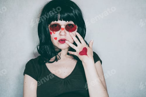 Preview: Cool portrait of a young woman wearing red glasses and full of red hearts