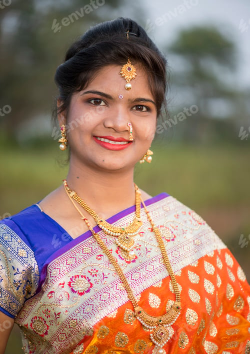 Preview: Beautiful Indian bride in traditional wedding dress at outdoor.