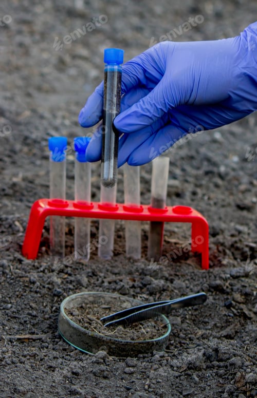 Preview: A scientist takes soil into a test tube for analysis. Selective focus.