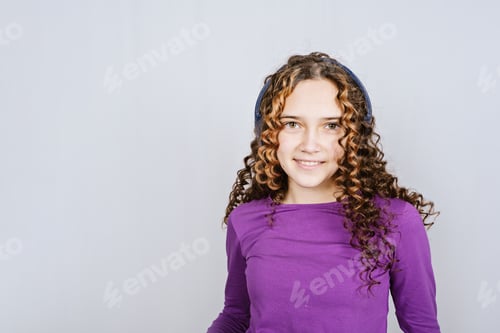 Preview: Portrait of beautiful smiling teen redhead girl with curly hair. Happy curly teenage girl