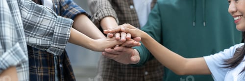 Preview: Group of happy multiethnic colleagues shaking hands Express joy in the creative team. Friends or stu