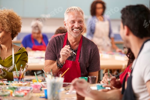 Preview: Group Of Mature Adults Attending Art Class In Community Centre