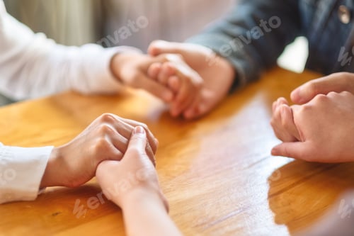 Preview: Group of people sitting in a circle holding hands and pray together or in therapy session