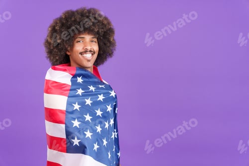 Preview: Happy african man wrapping with a north america national flag