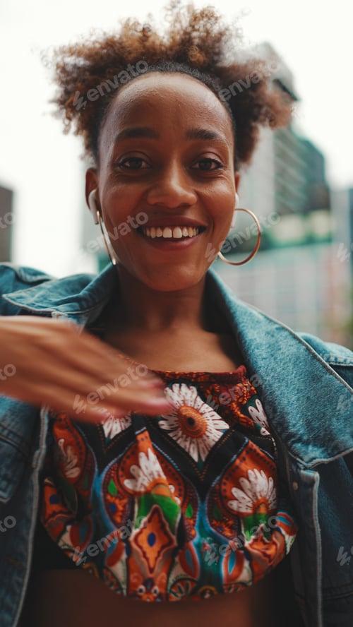 Preview: Closeup, smiling African listening to music on headphones and dancing outdoors.
