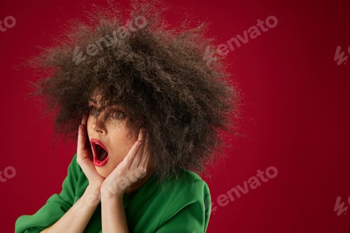 Preview: Positive young woman Afro hairstyle green dress emotions close-up color background unaltered