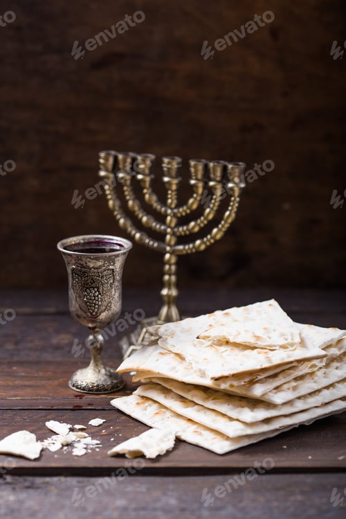 Preview: Red kosher wine with a white matzah or matza on a vintage wood background presented as a Passover