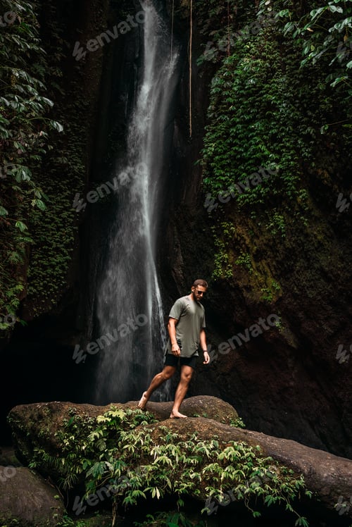 Preview: A man at the waterfall. A person travels around the world. The man at the waterfall. Travel to Bali