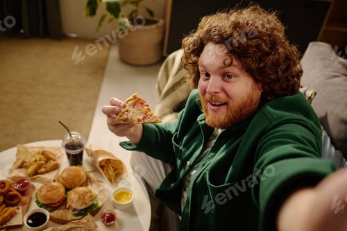 Preview: Young Man Enjoying a Fast Food Feast at Home