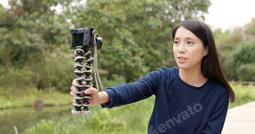 Preview: Woman taking video on camera for vlog