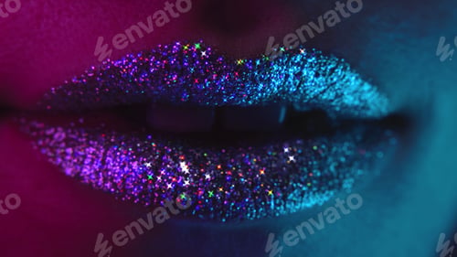 Preview: Fashion model with bright shiny sparkles on plump lips. Macro view of woman with glamorous