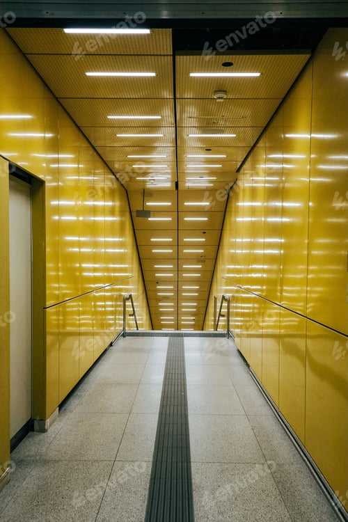 Preview: Vertical shot of a yellow hallway with illuminated straight lights