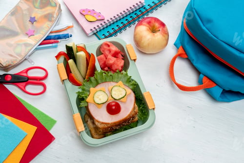 Preview: School lunch box for kids with food in the form of funny faces. Back to school concept