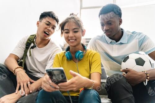 Preview: Teenager multiracial School friends watching smartphone together in the School Staircase