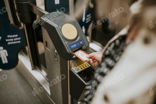 Preview: Person inserting a ticket into a train station turnstile