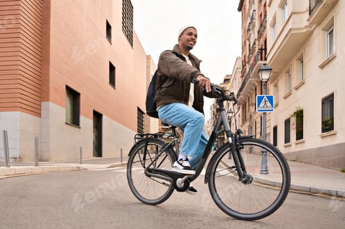 Preview: Stylish student riding his bicycle in the city center
