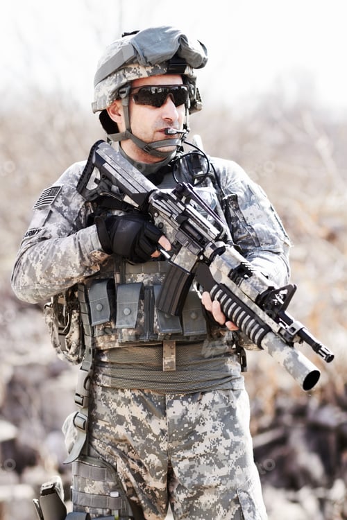 Preview: Warrior of war. A soldier standing with gun in hand in a desert environment.