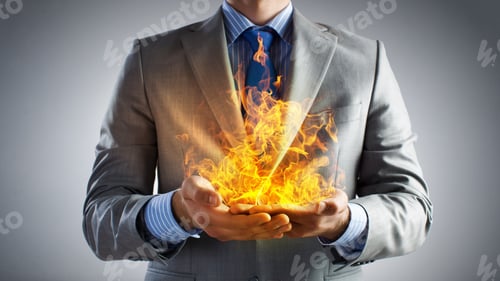 Preview: Young Businessman Holding Fire Flames In Palms