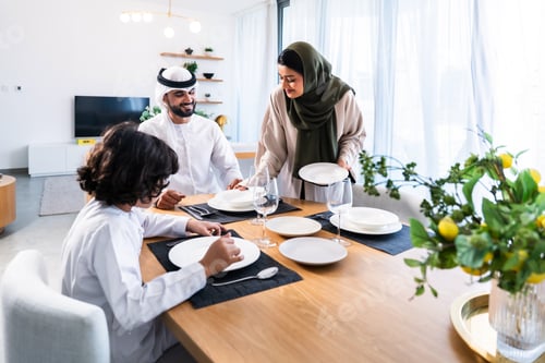Preview: Emirati family preparing dining table for meal at home