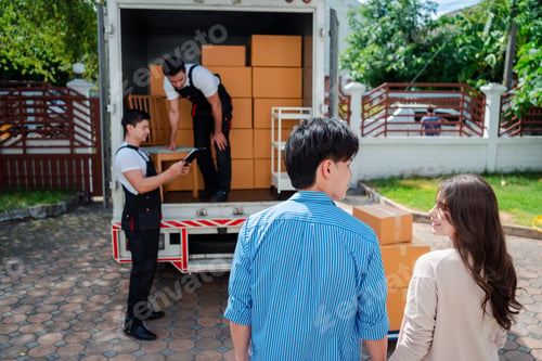 Preview: Asian Couple check while unloading boxes and furniture from a pickup truck