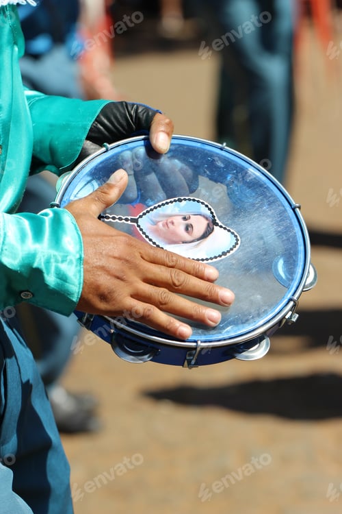 Preview: Close-up shot of man playing with tambourine with virgin mary's