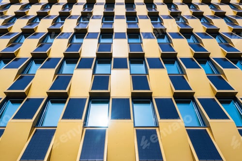 Preview: Low angle shot of solar panels with glass windows on a side of a building