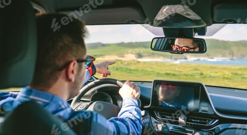 Preview: Young man holding steering and pointing driving