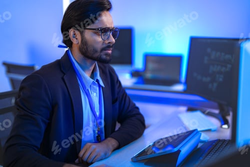 Preview: Stressed IT professional reacts with shock to a critical system error on his computer.