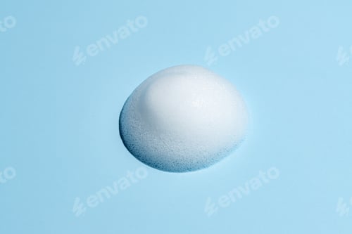 Preview: Face cleansing mousse of shampoo foam sample on blue background