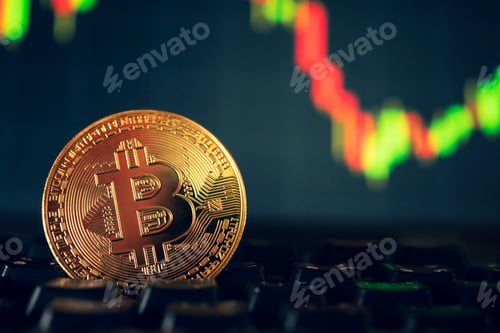 Preview: A golden coin with bitcoin symbol on computer keyboard with stock graph background.