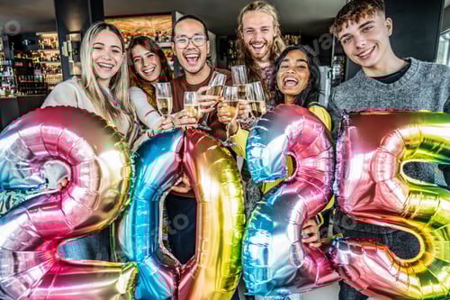 Preview: Happy group of friends cheering champagne wine and celebrating new 2025 year at bar