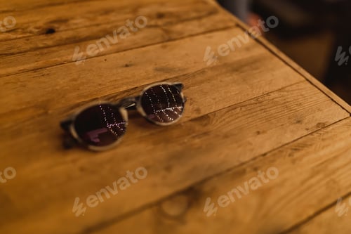 Preview: Glasses on a table. Lights reflecting in the glasses