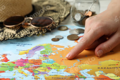 Preview: Woman with world map at table, closeup. Travel during summer vacation