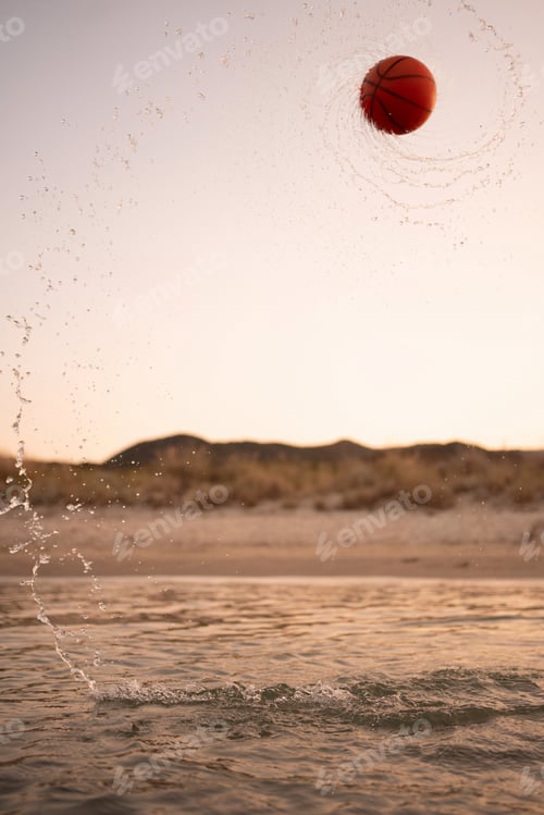 Preview: Family enjoying playful moments with a basketball at the beach