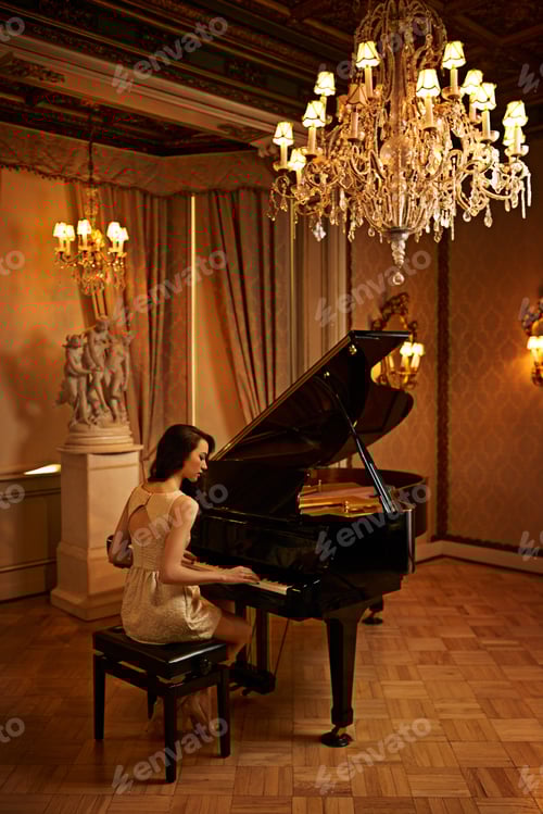 Preview: Classic perfection. Shot of a beautiful young woman playing the piano in an elegant room.