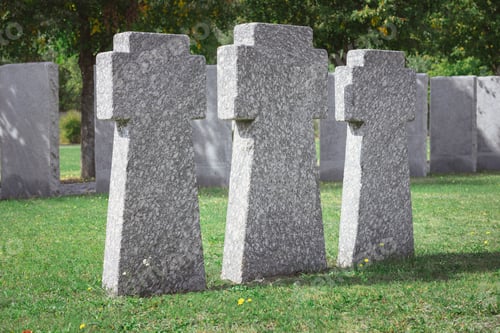 Preview: selective focus of memorial stone crosses placed in row at graveyard